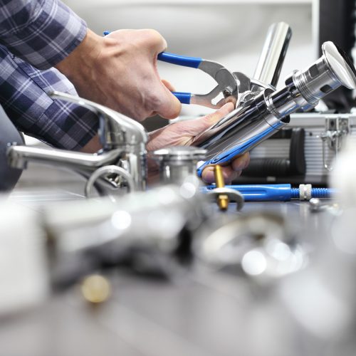 hands plumber at work in a bathroom, plumbing repair service, assemble and install concept